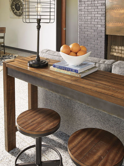 Torjin - 3 Pc. - Long Counter Table, 2 Stools - Dark Brown